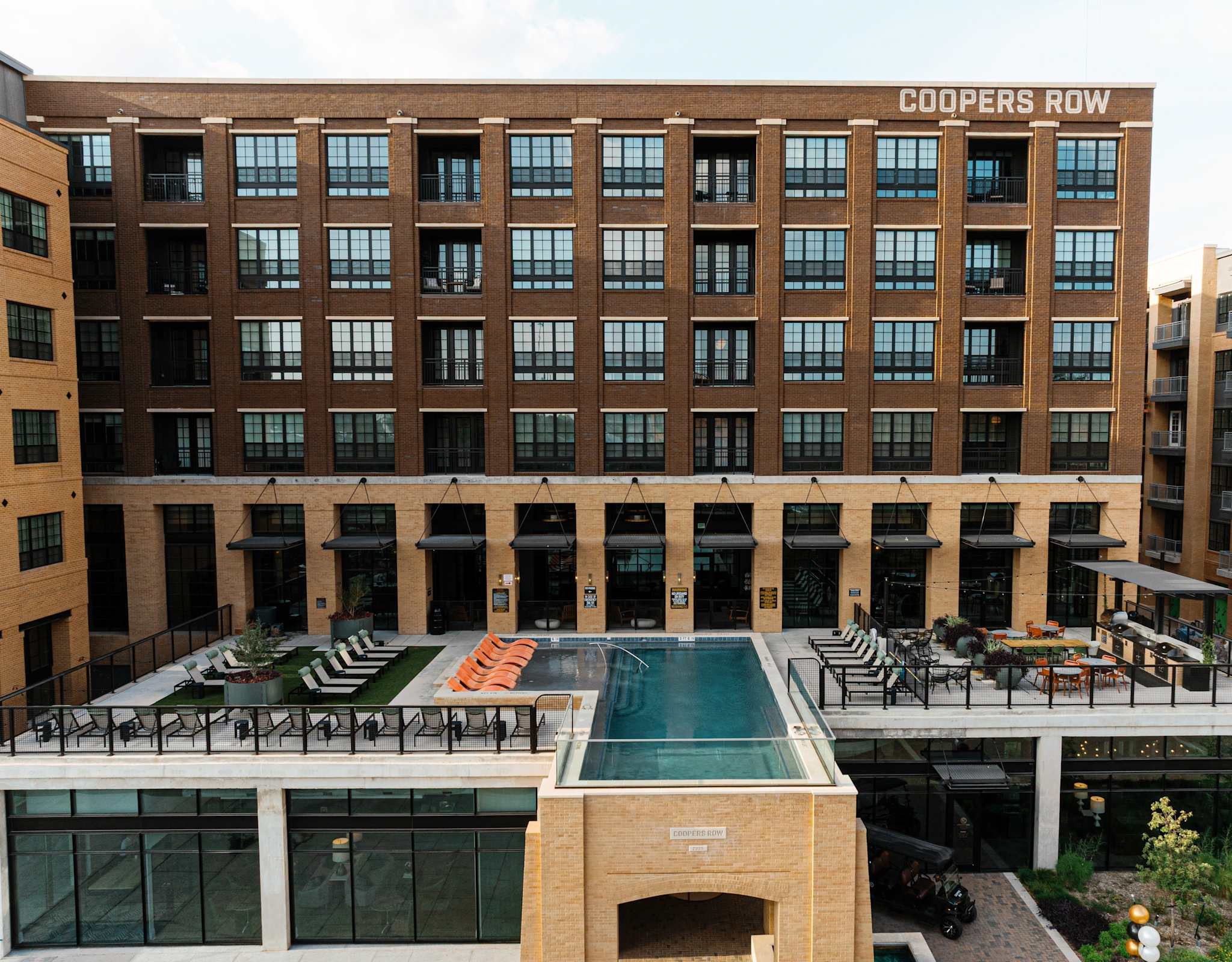 Coopers Row — building identity signage, courtyard and pool deck at a Dallas mixed-use property
